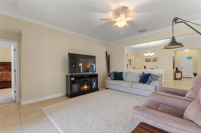 1353 Palmetto Dunes St, Davenport, FL 33836 - living area with light tile patterned floors, crown molding, a glass covered fireplace, a ceiling fan, and a chandelier