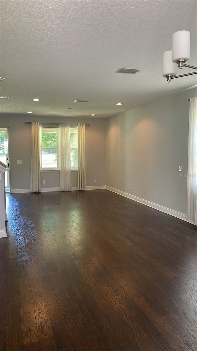 2813 Roseglen Way, Orlando, FL 32812 - unfurnished room with plenty of natural light, dark wood finished floors, a textured ceiling, and recessed lighting