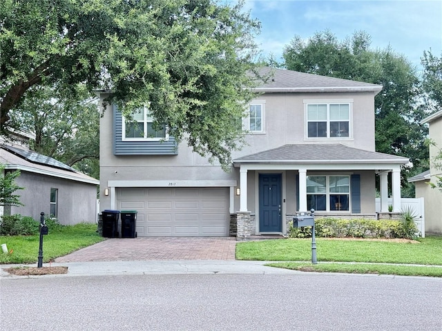 2813 Roseglen Way, Orlando, FL 32812 - view of front of house with stucco siding, an attached garage, a front yard, and decorative driveway