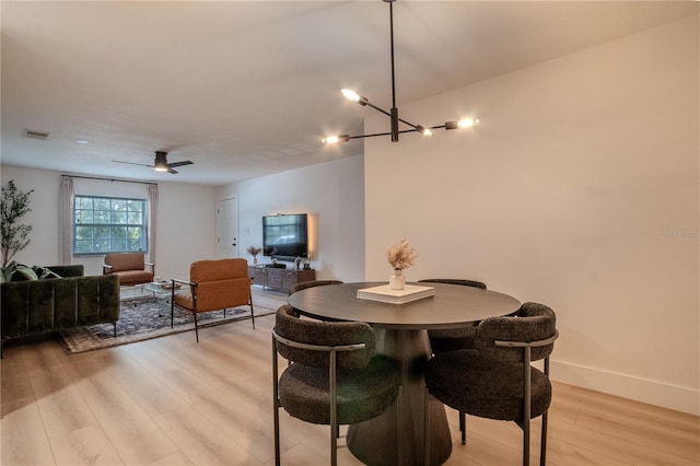 4768 Tangerine Ave Unit 4768, Winter Park, FL 32792 - dining space with light wood-style flooring, a chandelier, and a ceiling fan