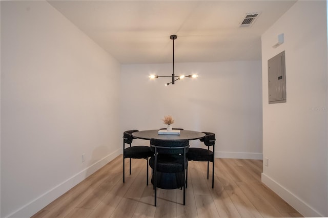 4768 Tangerine Ave Unit 4768, Winter Park, FL 32792 - dining room featuring electric panel, a chandelier, and light wood-style floors