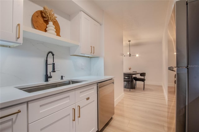 4768 Tangerine Ave Unit 4768, Winter Park, FL 32792 - kitchen featuring stainless steel dishwasher, freestanding refrigerator, open shelves, and light countertops