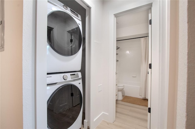 4768 Tangerine Ave Unit 4768, Winter Park, FL 32792 - laundry room with stacked washer and clothes dryer and light wood-style floors