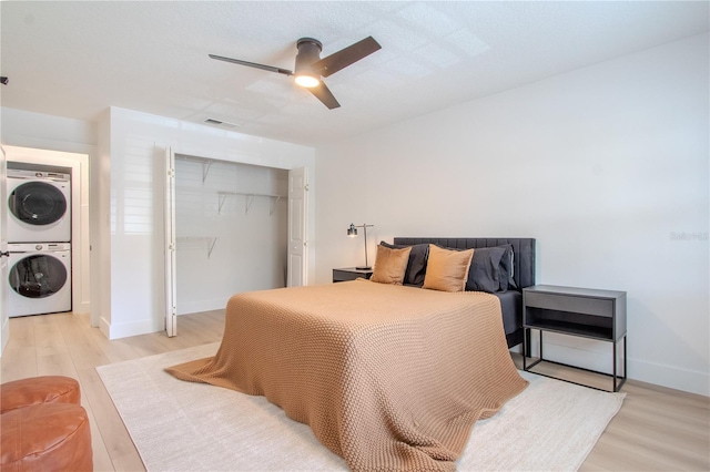 4768 Tangerine Ave Unit 4768, Winter Park, FL 32792 - bedroom featuring stacked washer / dryer, a closet, light wood-style floors, and ceiling fan