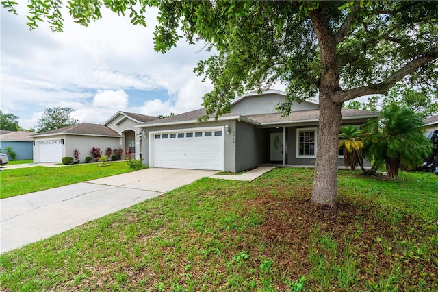 1659 Sage Creek Ct, Orlando, FL 32824 - ranch-style home featuring a garage, driveway, a front yard, and stucco siding