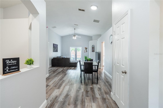 1659 Sage Creek Ct, Orlando, FL 32824 - dining area featuring vaulted ceiling, wood finished floors, ceiling fan, baseboards, and arched walkways