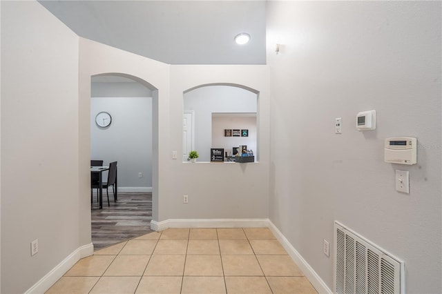 1659 Sage Creek Ct, Orlando, FL 32824 - corridor with light tile patterned floors, arched walkways, and baseboards