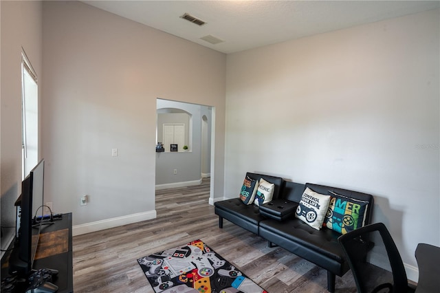 1659 Sage Creek Ct, Orlando, FL 32824 - living room with wood finished floors, baseboards, and arched walkways