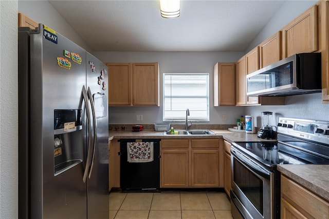1659 Sage Creek Ct, Orlando, FL 32824 - kitchen with stainless steel appliances, a sink, light tile patterned floors, and light brown cabinetry