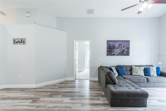 1659 Sage Creek Ct, Orlando, FL 32824 - living room with wood finished floors, ceiling fan, baseboards, and lofted ceiling