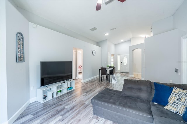 1659 Sage Creek Ct, Orlando, FL 32824 - living room featuring arched walkways, a ceiling fan, vaulted ceiling, wood finished floors, and baseboards