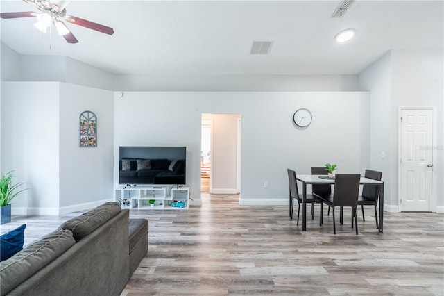 1659 Sage Creek Ct, Orlando, FL 32824 - living room with light wood finished floors, a ceiling fan, and baseboards