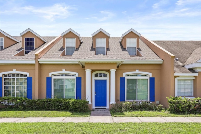 2050 Island Walk Dr, Orlando, FL 32824 - view of front of home with a shingled roof and stucco siding