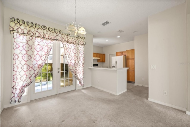 2050 Island Walk Dr, Orlando, FL 32824 - unfurnished living room with french doors, a chandelier, light carpet, and recessed lighting