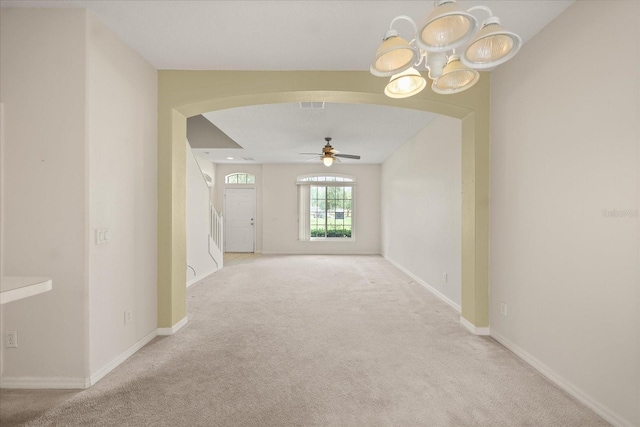 2050 Island Walk Dr, Orlando, FL 32824 - unfurnished room featuring arched walkways, carpet, a ceiling fan, and a chandelier