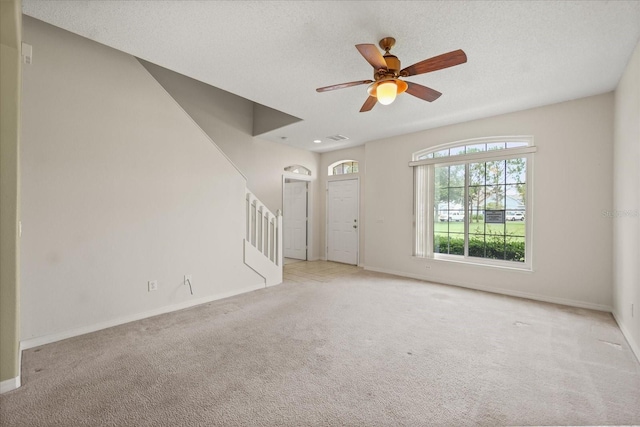 2050 Island Walk Dr, Orlando, FL 32824 - unfurnished living room with carpet, stairs, and a ceiling fan