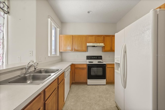 2050 Island Walk Dr, Orlando, FL 32824 - kitchen with white appliances, under cabinet range hood, light countertops, brown cabinets, and a textured ceiling