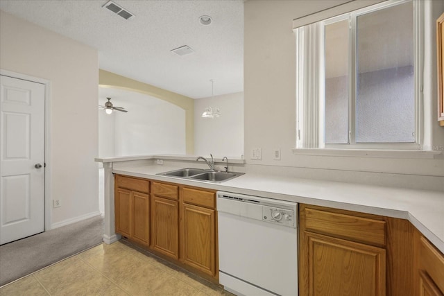 2050 Island Walk Dr, Orlando, FL 32824 - kitchen with dishwasher, brown cabinets, light countertops, a ceiling fan, and a textured ceiling