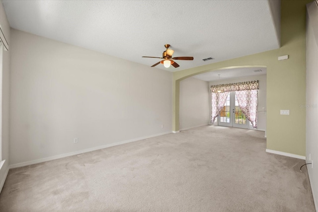 2050 Island Walk Dr, Orlando, FL 32824 - unfurnished room with arched walkways, light carpet, a ceiling fan, and a textured ceiling