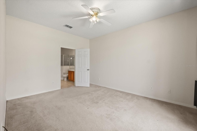 2050 Island Walk Dr, Orlando, FL 32824 - unfurnished bedroom featuring light colored carpet, ensuite bathroom, ceiling fan, and a textured ceiling