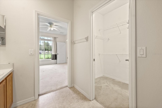 2050 Island Walk Dr, Orlando, FL 32824 - bathroom featuring vanity, a ceiling fan, and a walk in closet
