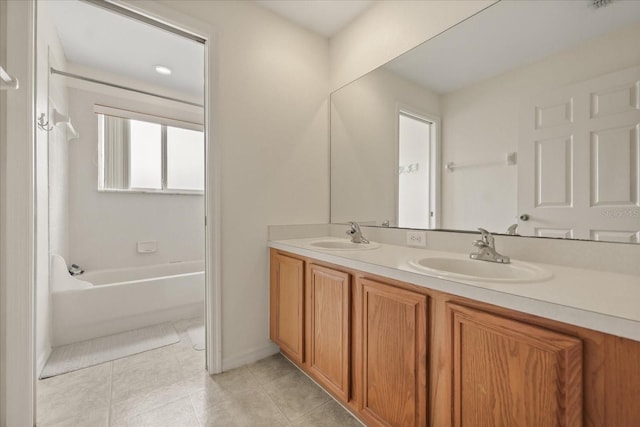 2050 Island Walk Dr, Orlando, FL 32824 - bathroom with double vanity, tile patterned flooring, and washtub / shower combination