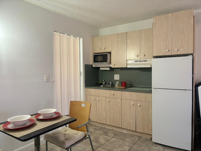 43420 Hwy 27 Unit 150, Davenport, FL 33837 - kitchen featuring freestanding refrigerator, light brown cabinets, ventilation hood, black microwave, and dark countertops