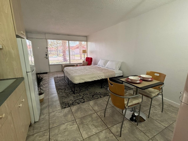 43420 Hwy 27 Unit 150, Davenport, FL 33837 - bedroom with a textured ceiling and freestanding refrigerator