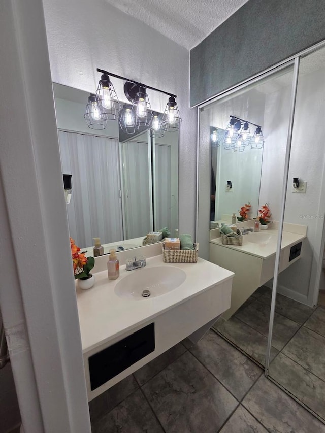43420 Hwy 27 Unit 150, Davenport, FL 33837 - bathroom with vanity, a textured ceiling, tile patterned floors, and a textured wall