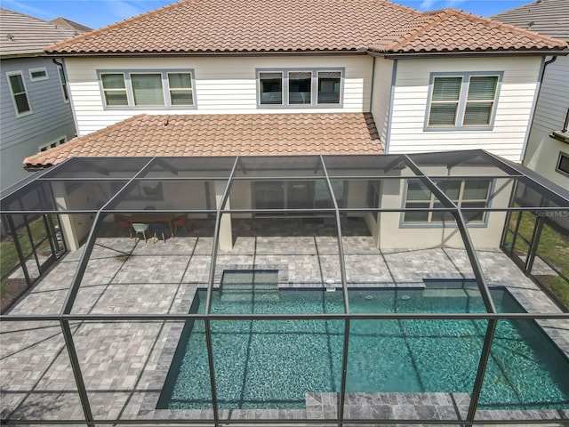 9071 Woodland Forest Rd, Orlando, FL 32836 - rear view of house featuring a tile roof, a patio, and an outdoor pool