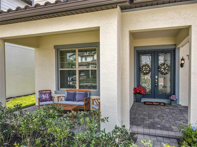9071 Woodland Forest Rd, Orlando, FL 32836 - entrance to property featuring french doors, stucco siding, and covered porch