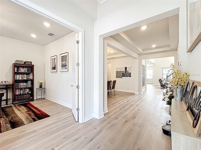 9071 Woodland Forest Rd, Orlando, FL 32836 - hallway featuring light wood finished floors, recessed lighting, and a tray ceiling