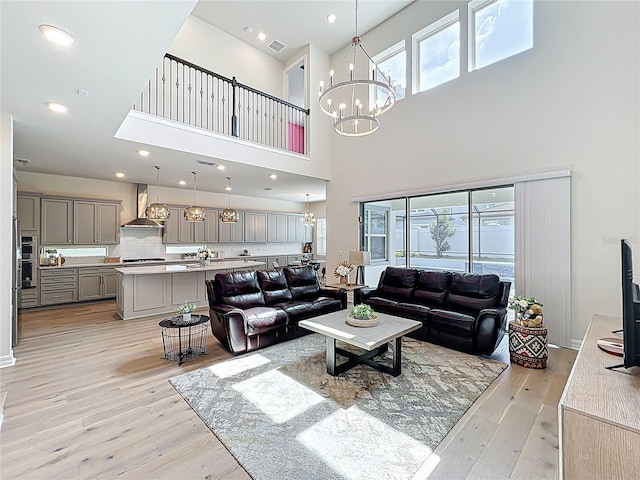 9071 Woodland Forest Rd, Orlando, FL 32836 - living area with a chandelier, light wood-type flooring, healthy amount of natural light, and a towering ceiling