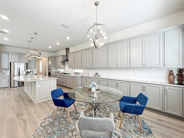 9071 Woodland Forest Rd, Orlando, FL 32836 - dining area with a chandelier, light wood-style floors, and recessed lighting