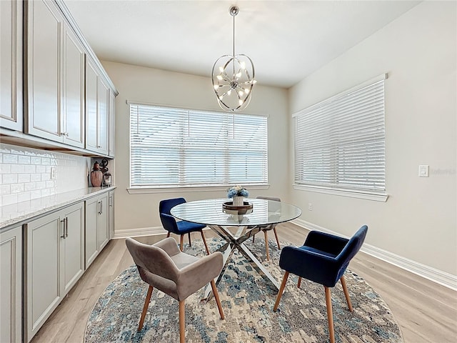 9071 Woodland Forest Rd, Orlando, FL 32836 - dining room with light wood-type flooring and a chandelier