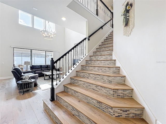 9071 Woodland Forest Rd, Orlando, FL 32836 - stairway with a high ceiling, a chandelier, and hardwood / wood-style floors