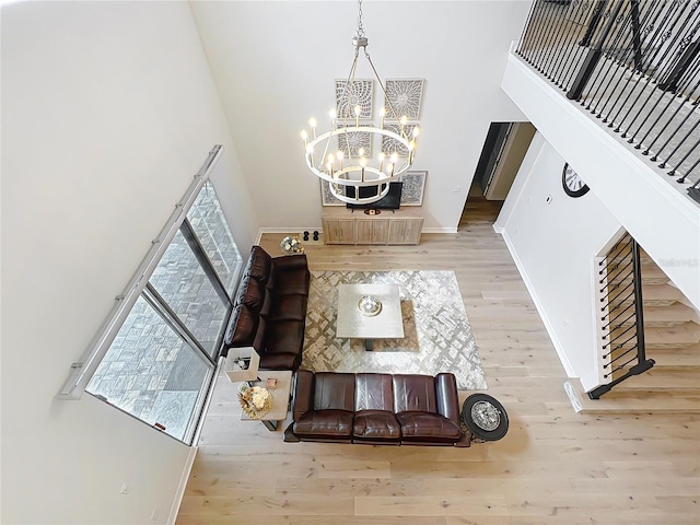9071 Woodland Forest Rd, Orlando, FL 32836 - living room with a high ceiling, a chandelier, and wood finished floors