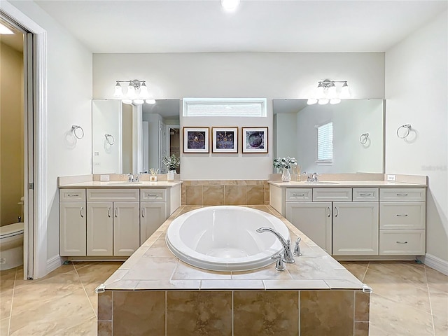 9071 Woodland Forest Rd, Orlando, FL 32836 - bathroom with a bath, two vanities, and tile patterned flooring