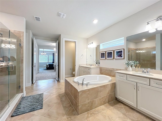 9071 Woodland Forest Rd, Orlando, FL 32836 - full bath featuring a stall shower, two vanities, tile patterned floors, and a bath
