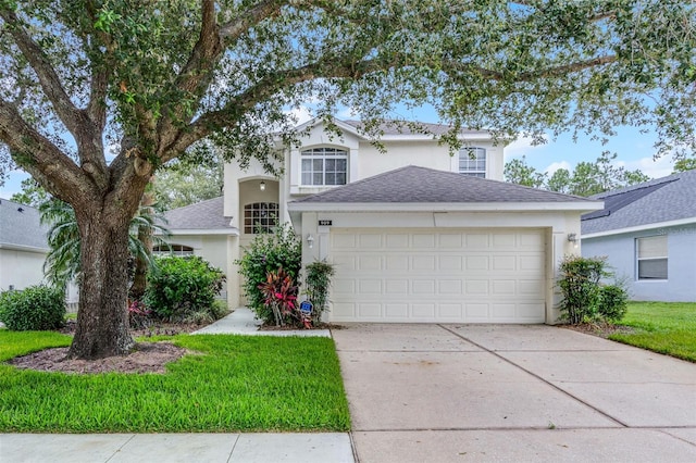 909 Troon Cir, Davenport, FL 33897 - traditional-style home with stucco siding, driveway, an attached garage, and a shingled roof