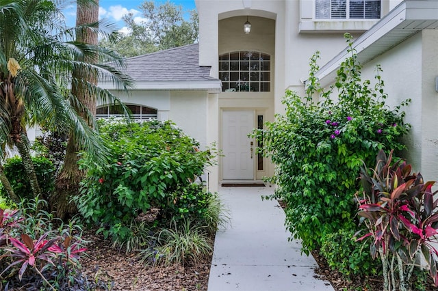 909 Troon Cir, Davenport, FL 33897 - entrance to property with stucco siding and roof with shingles