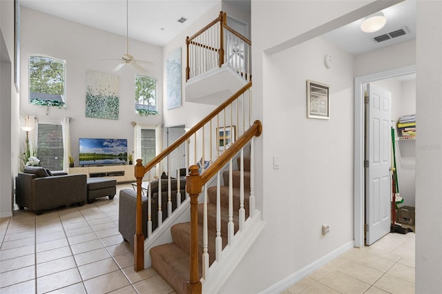 909 Troon Cir, Davenport, FL 33897 - stairs featuring tile patterned floors, a ceiling fan, and a high ceiling
