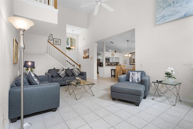 909 Troon Cir, Davenport, FL 33897 - living area with a high ceiling, stairs, light tile patterned floors, and a ceiling fan