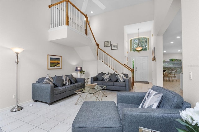909 Troon Cir, Davenport, FL 33897 - living room with stairway, light tile patterned floors, a high ceiling, recessed lighting, and a ceiling fan