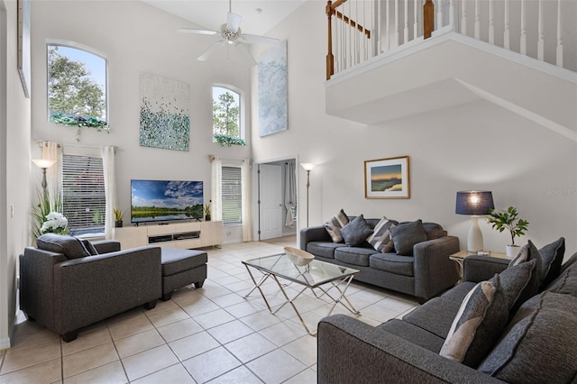 909 Troon Cir, Davenport, FL 33897 - living room with a towering ceiling, light tile patterned floors, and a ceiling fan