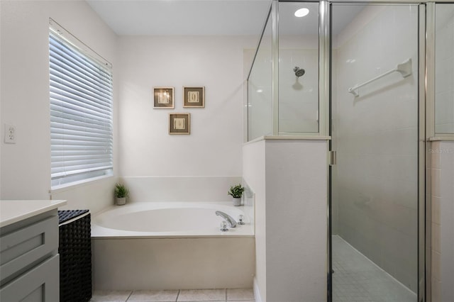 909 Troon Cir, Davenport, FL 33897 - full bath with a bath, vanity, a shower stall, and tile patterned flooring