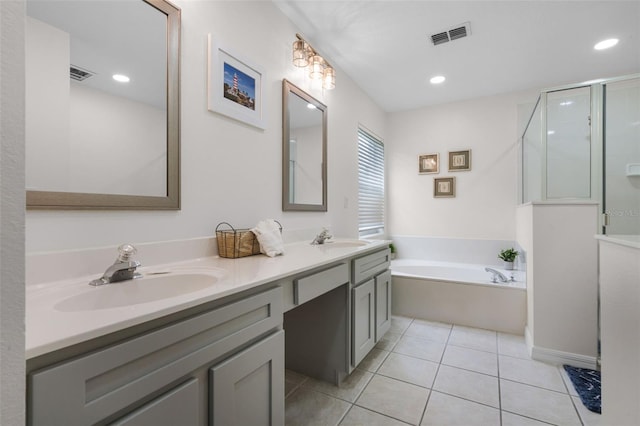 909 Troon Cir, Davenport, FL 33897 - full bath with double vanity, a bath, a stall shower, tile patterned flooring, and recessed lighting