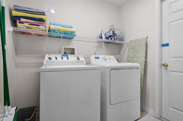 909 Troon Cir, Davenport, FL 33897 - washroom with washer and dryer and tile patterned floors