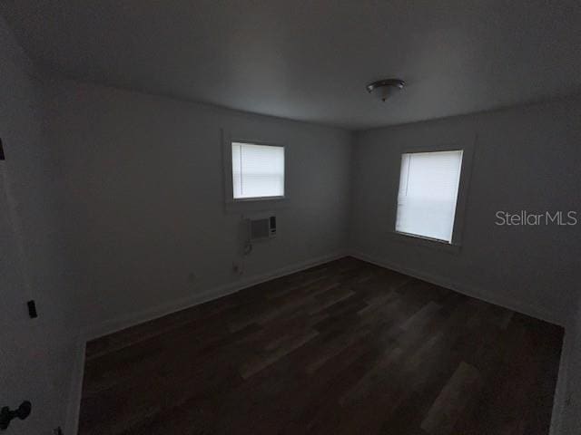 3029 Azalea Ave, Lake Wales, FL 33898 - unfurnished room featuring dark wood finished floors and a wall unit AC