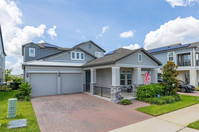 5133 Citrus Leaf Blvd, Winter Garden, FL 34787 - craftsman-style home with a porch, stucco siding, stone siding, decorative driveway, and a garage